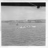 Skiff racing with the referee in the middle boat.