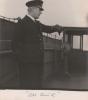 A ship’s captain standing on the deck of the ship.