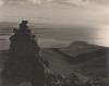 A stone cairn on a mountaintop overlooking the sea