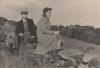 Man and woman sitting on a stone wall