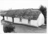 A roof thatched with rye straw roped and weighted with iron bars in Donegal.